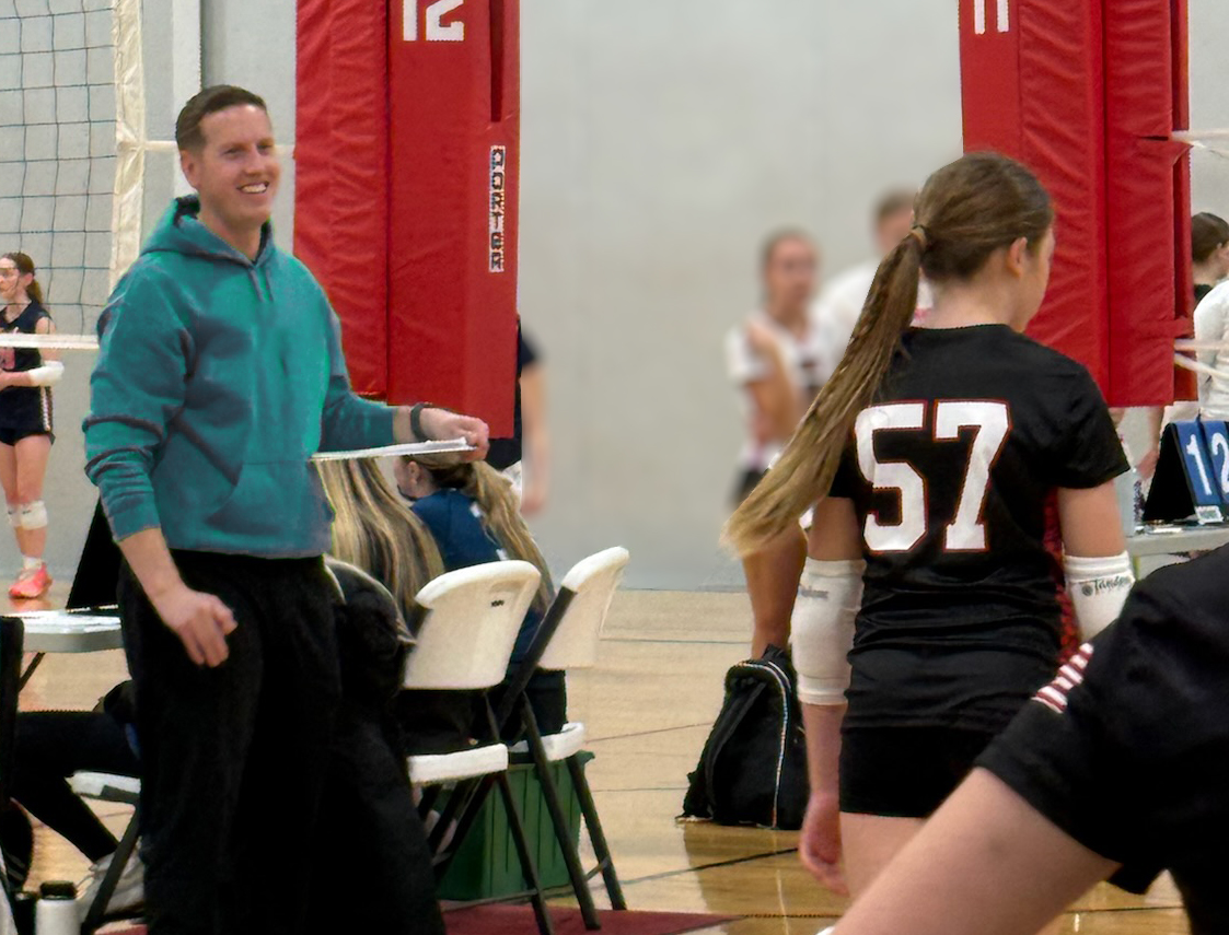 Stealth Volleyball Club coach demonstrating technique to an Omaha athlete